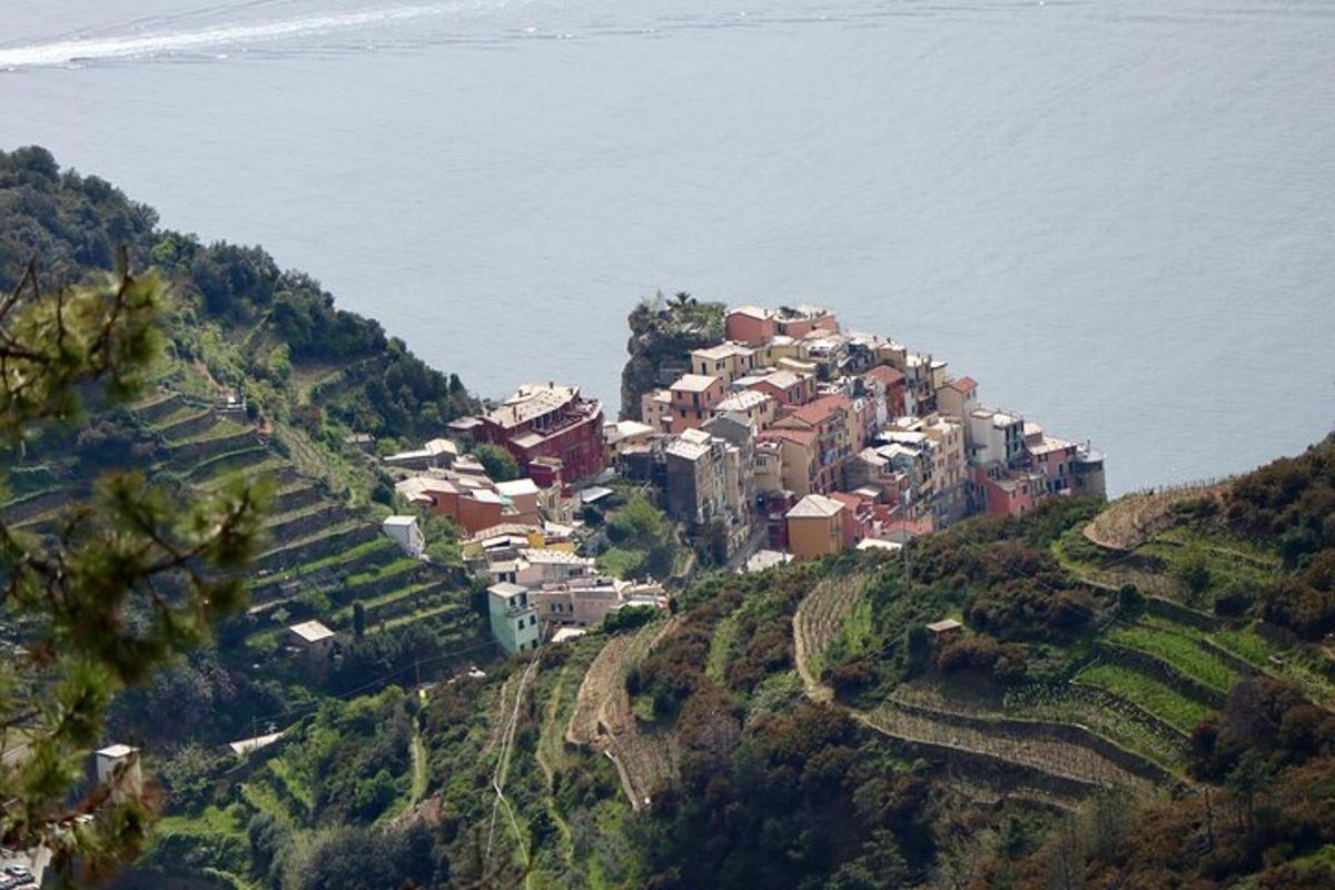 a village on a hill next to the water