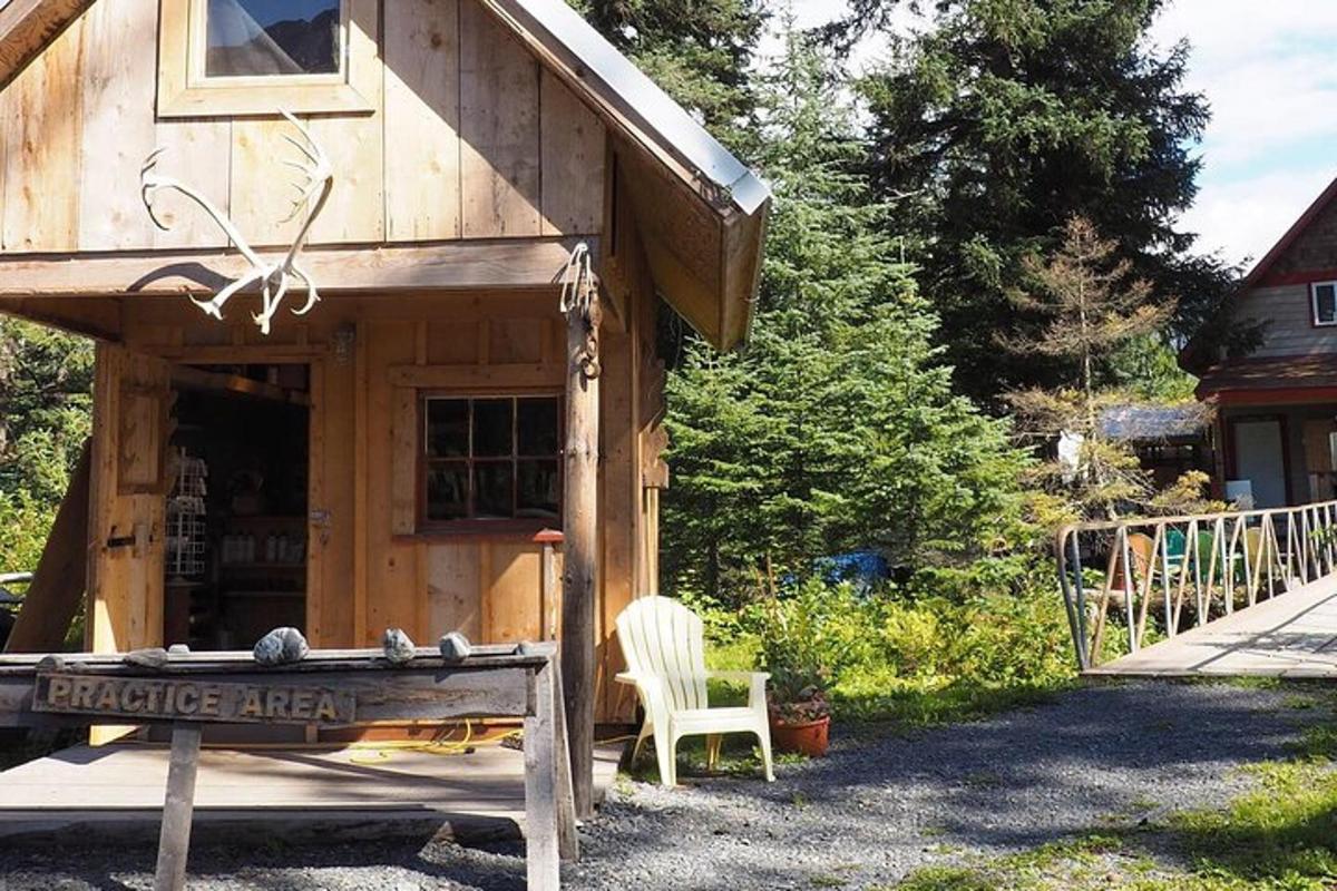 a small wooden cabin with a chair in front of it