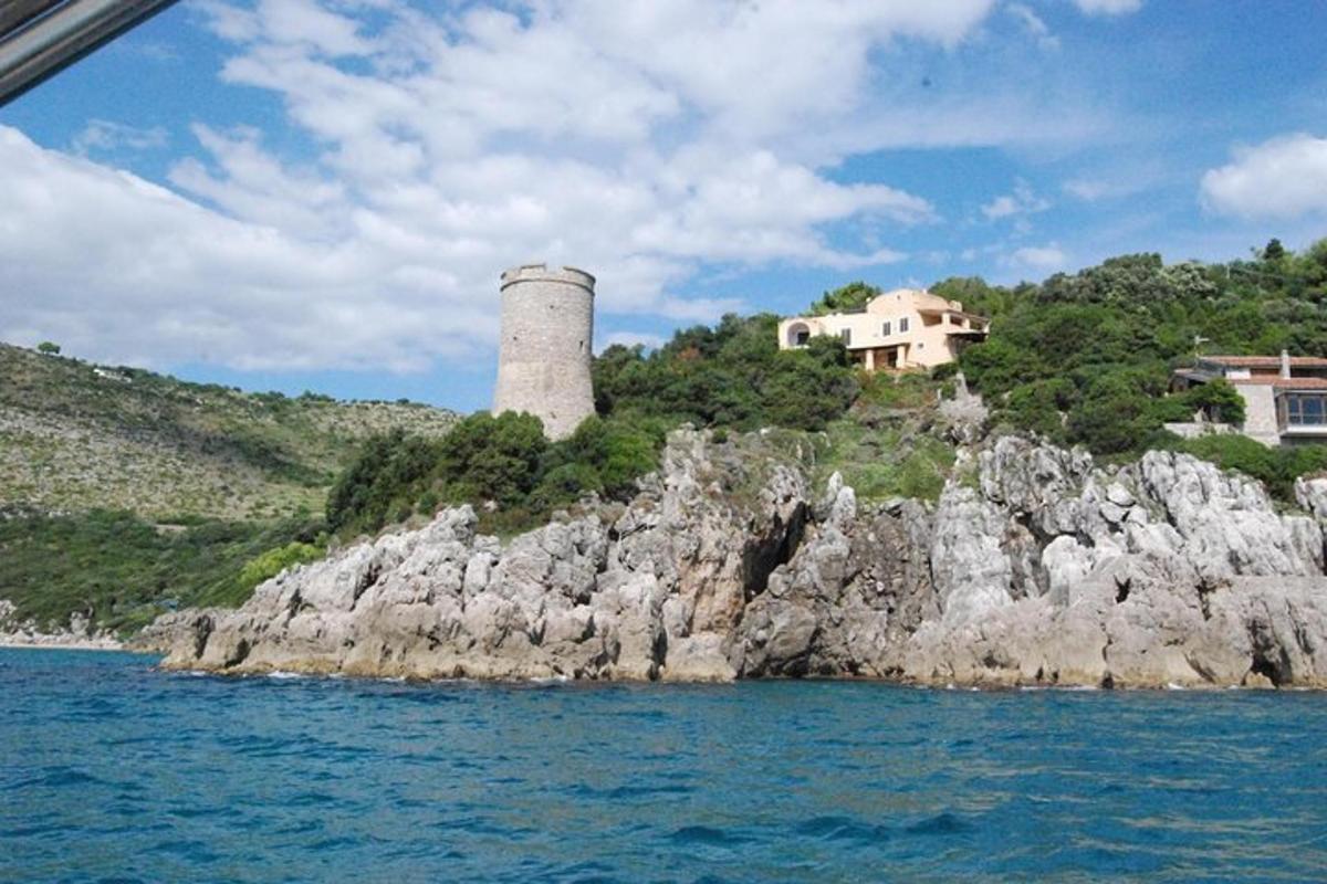a house on top of a rocky island in the water