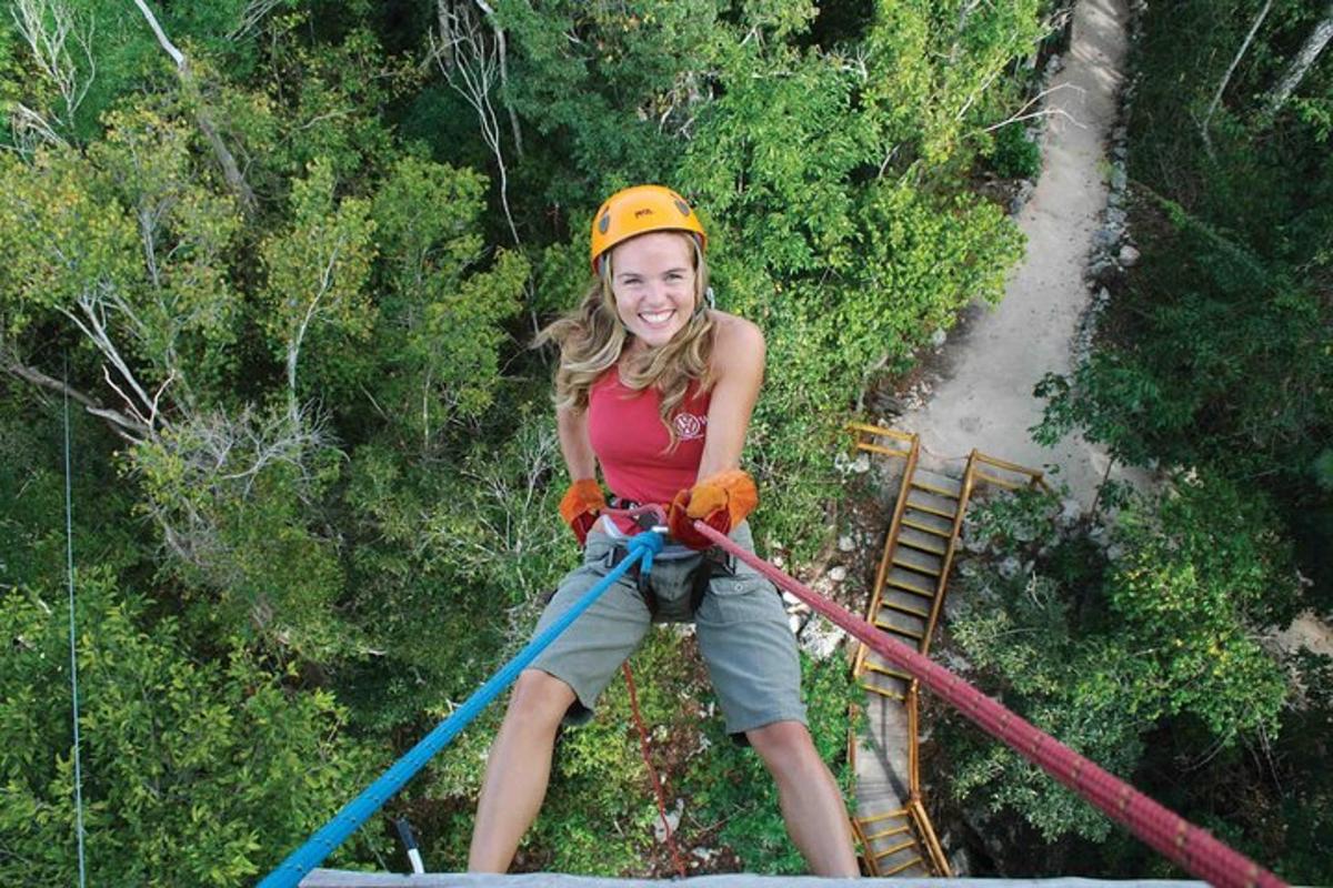 a girl on a zip line in the jungle