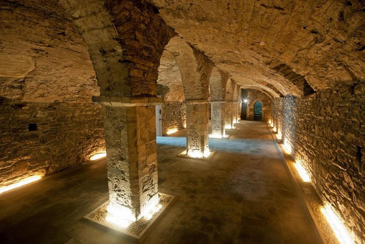a tunnel with columns and lights in a building