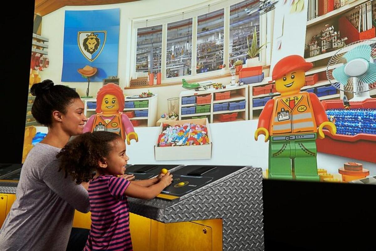 a woman and a little girl in a lego kitchen