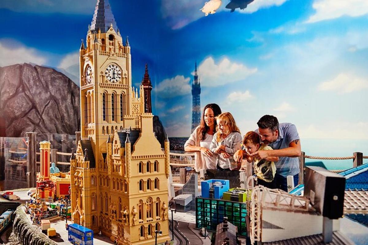 a family playing with a lego model of a clock tower