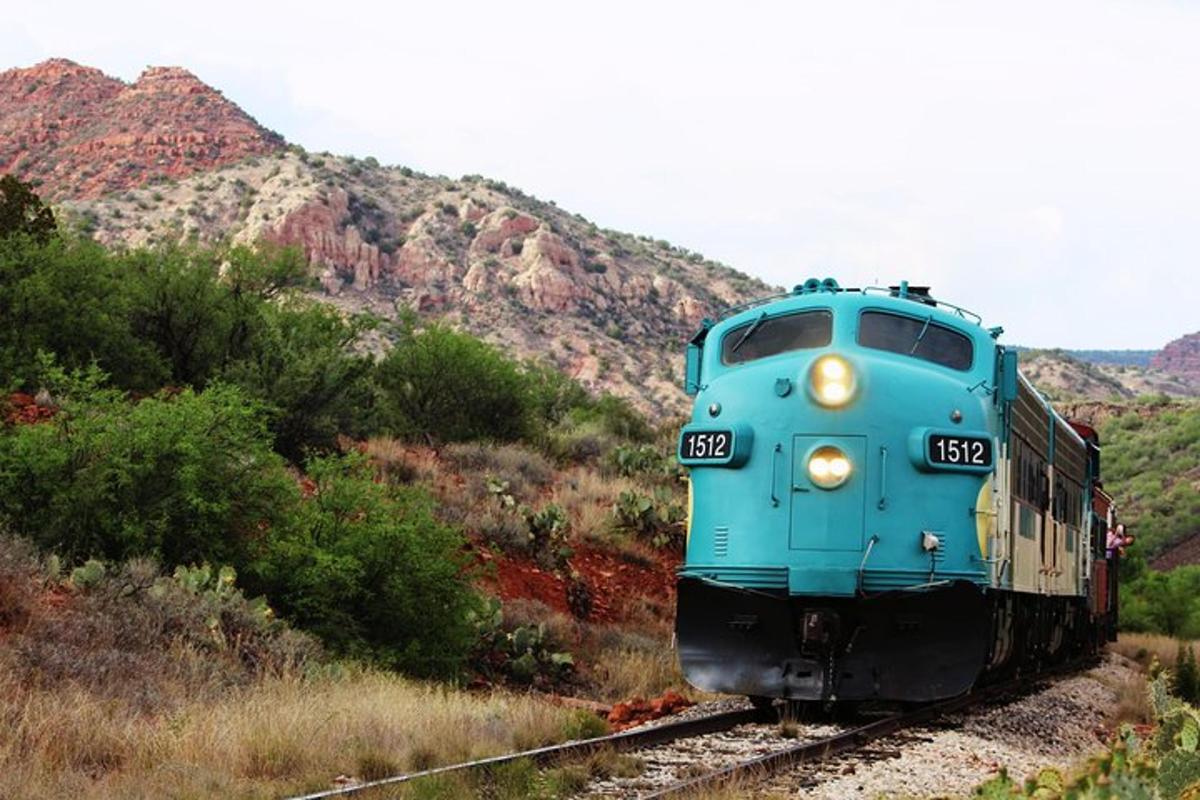 a blue train is traveling down the tracks