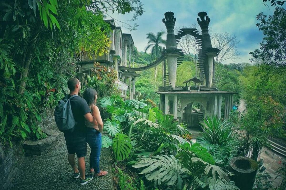 a man and woman standing in front of a garden