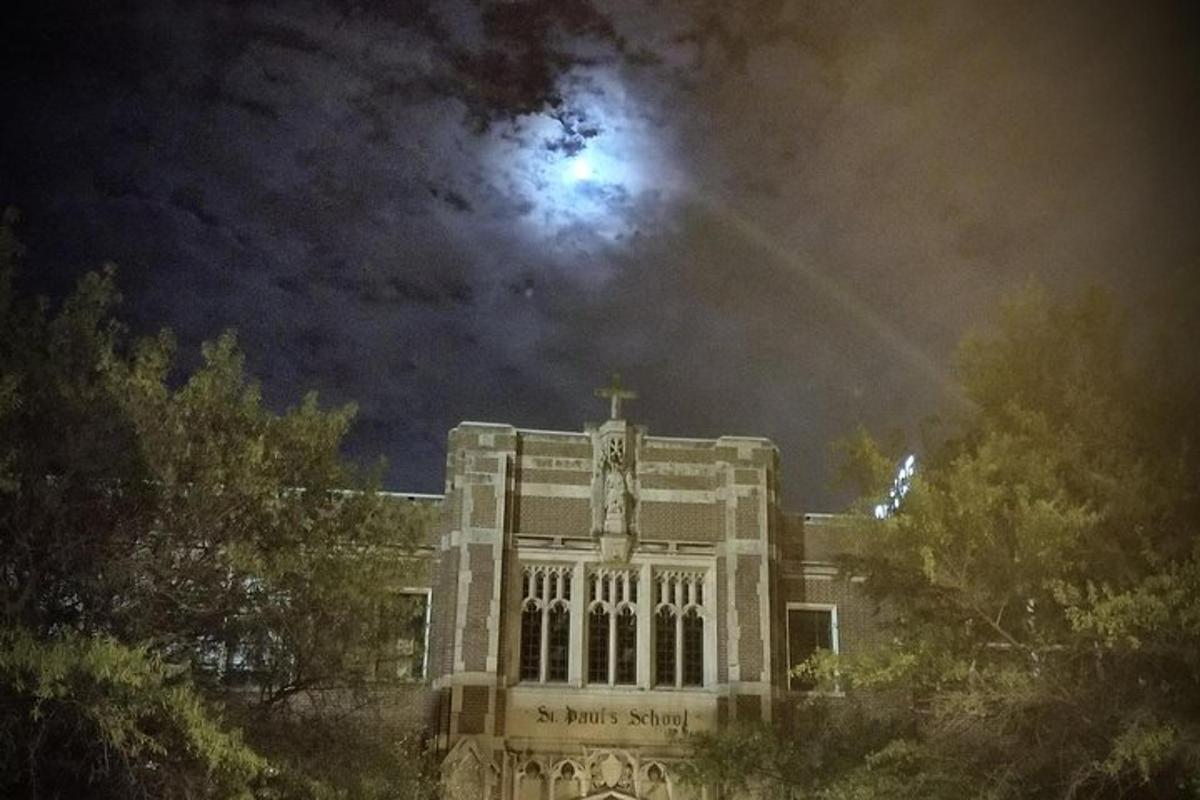 a large building with the moon in the sky