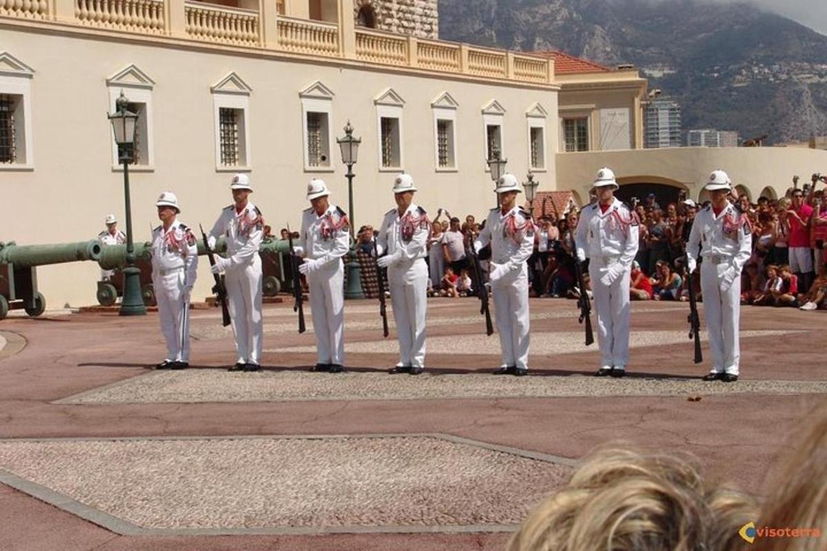 skupina mužů v bílých uniformách stojících v průvodu
