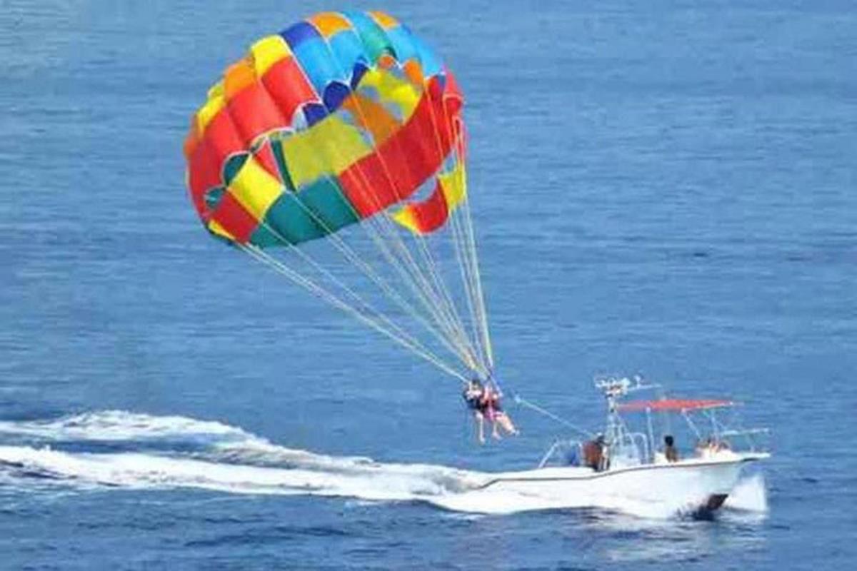 ein großer Fallschirm, der über einem Boot im Wasser fliegt