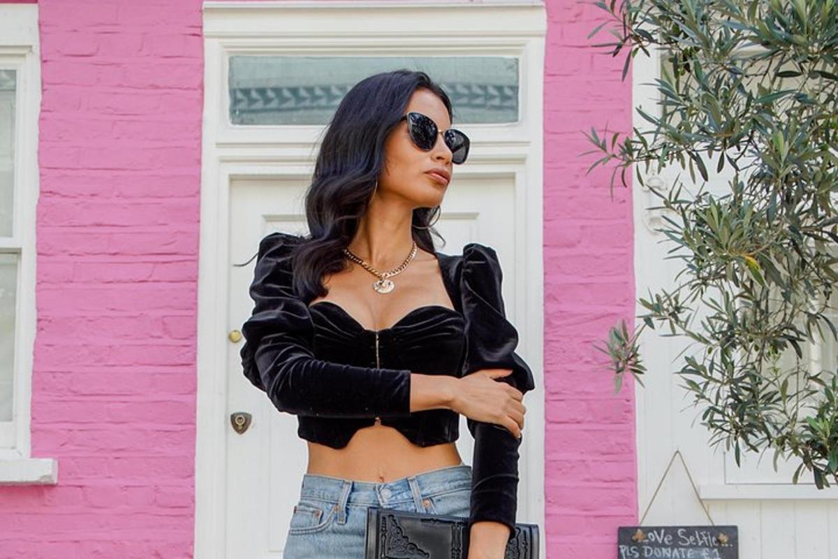 a woman wearing a black crop top and jeans