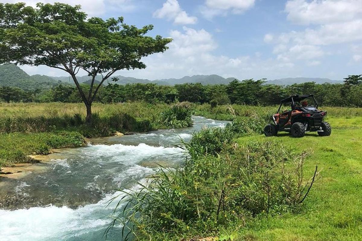 a person in a atv driving down a river