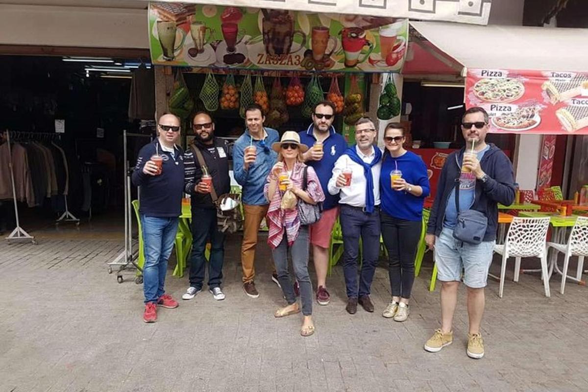 a group of people posing for a picture in front of a store