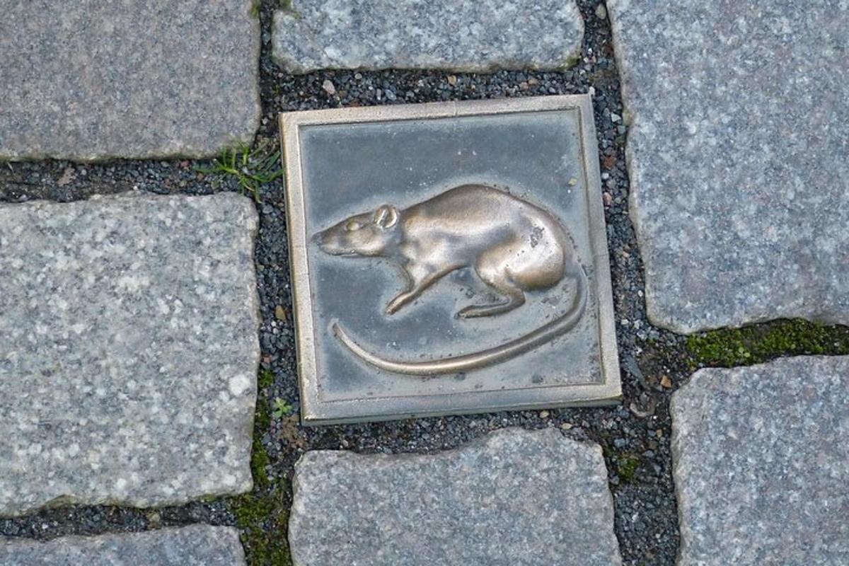 a figurine of a rat on the ground