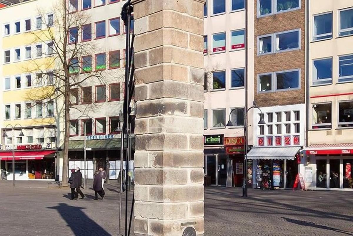 a tall building with people walking in a city street