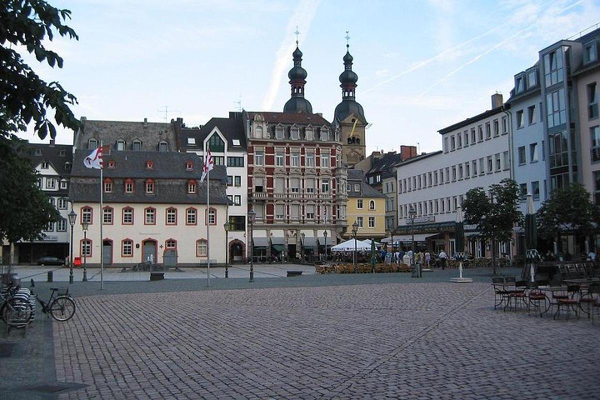 a city square with buildings and a cobblestone street