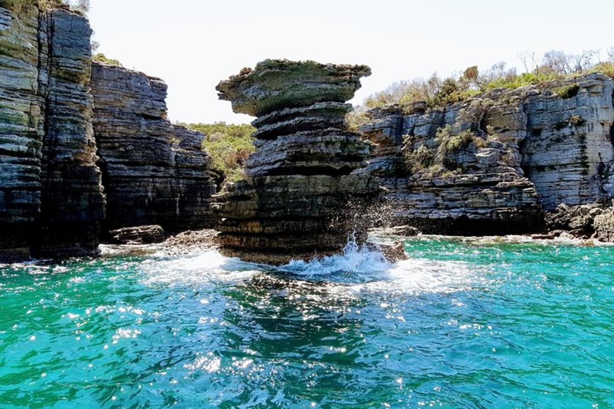 a person is in the water near some rocks