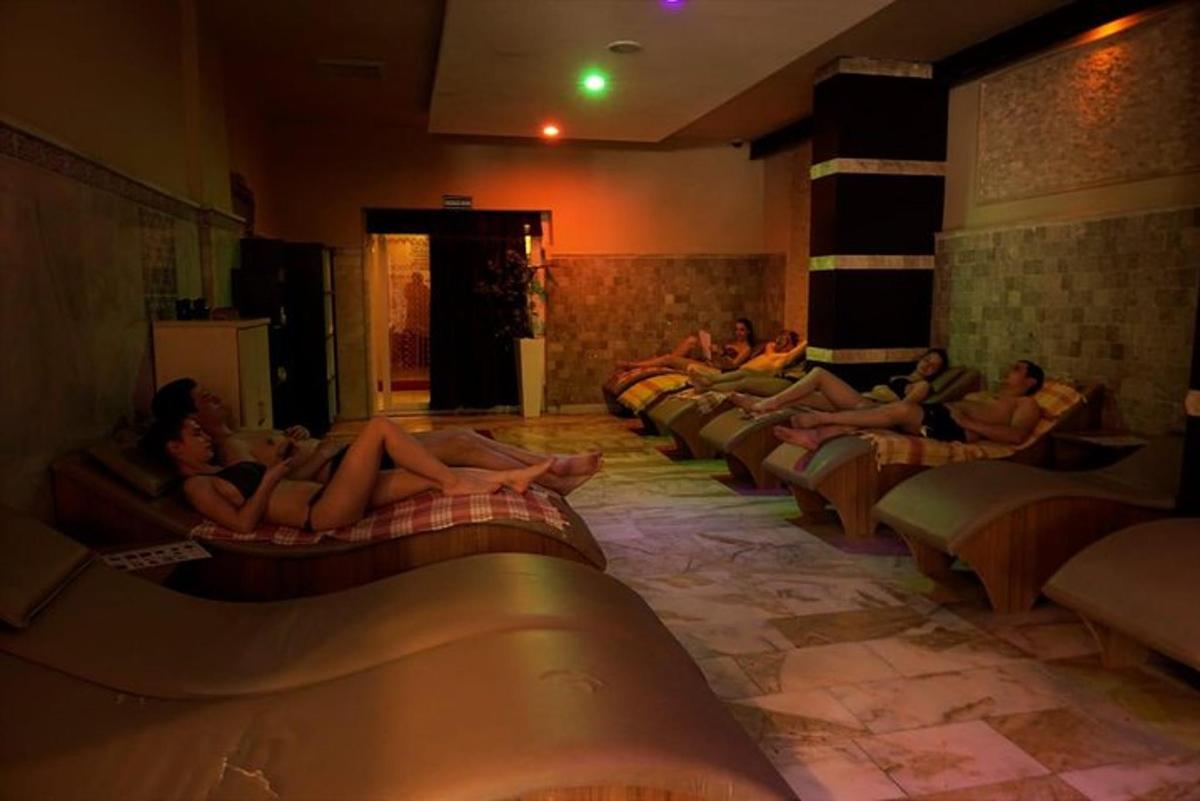 a group of people laying on their beds in a swimming pool