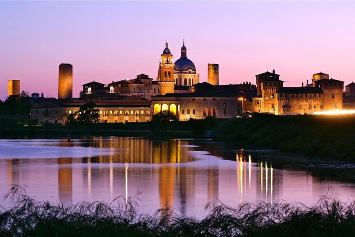 a view of a castle at night with a body of water