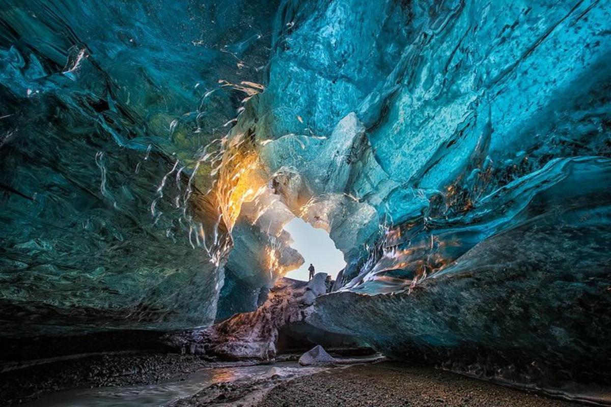 an ice cave with a person inside of it
