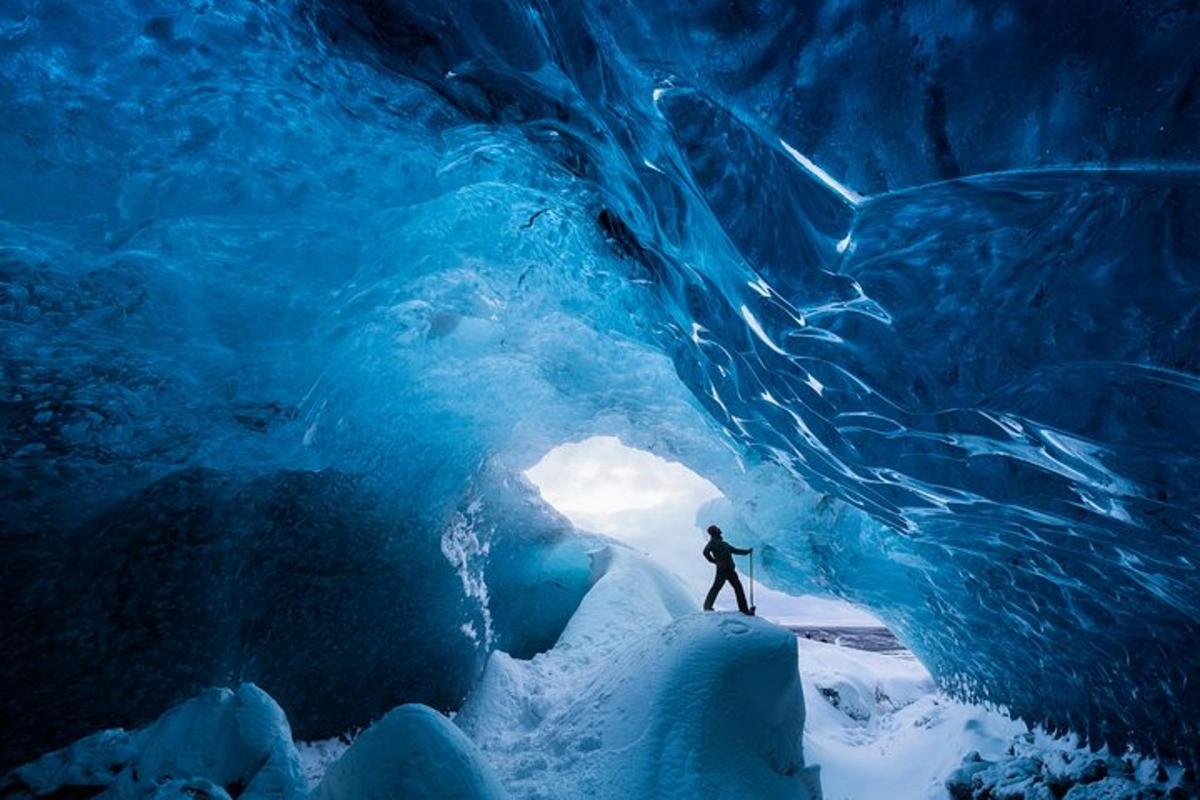 a person is standing inside an ice cave