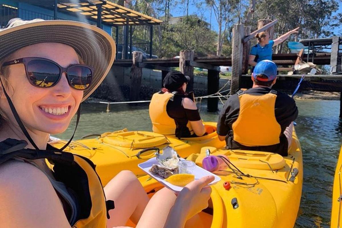 a woman in a yellow kayak on the water
