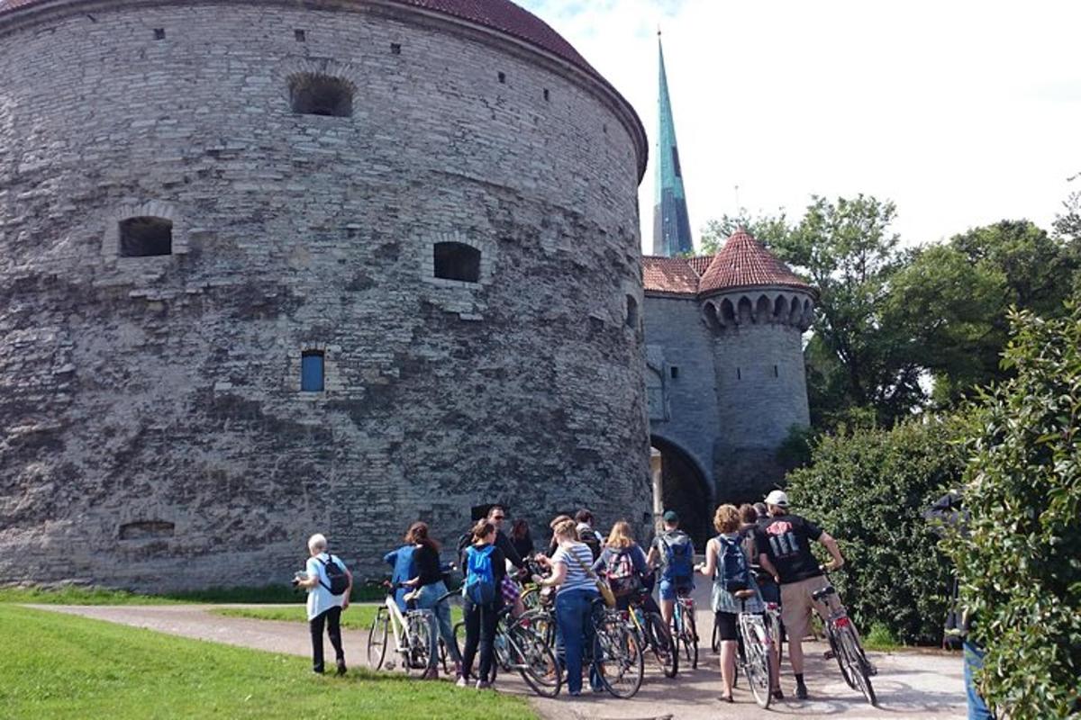 a group of people on bikes in front of a castle