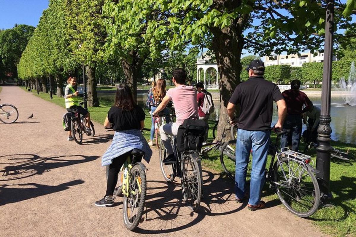 a group of people riding bikes in a park