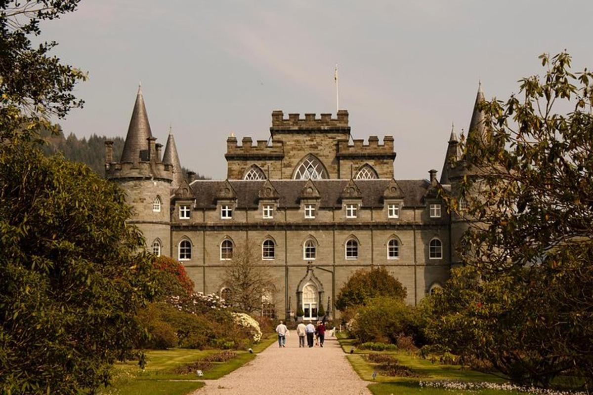 a large castle with people walking in front of it