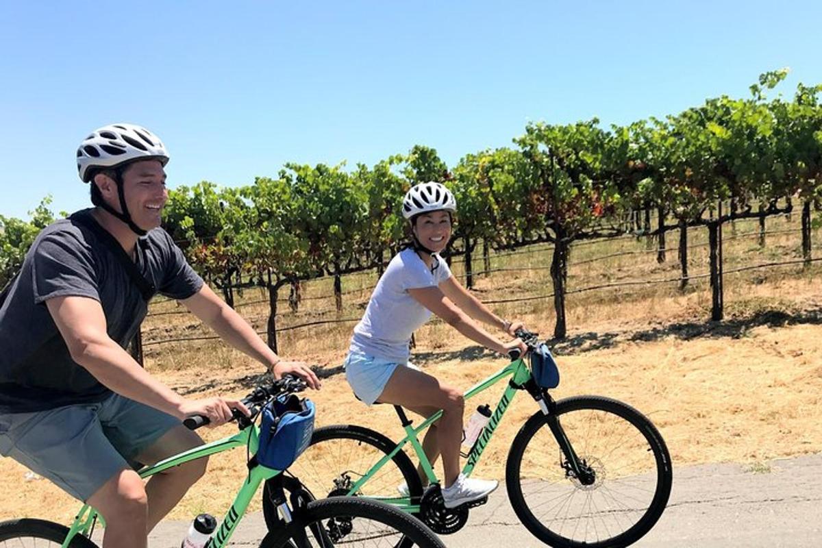 a man and a woman riding bikes down a road