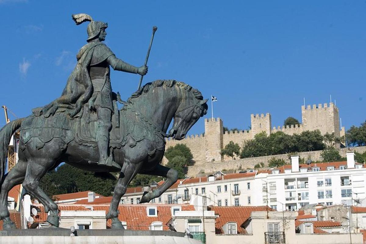 a statue of a man riding a horse with a castle in the background