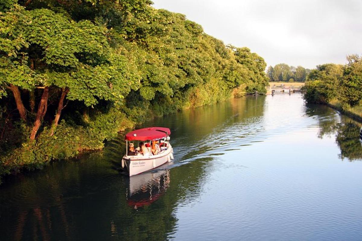 a boat with a red roof is traveling down a river