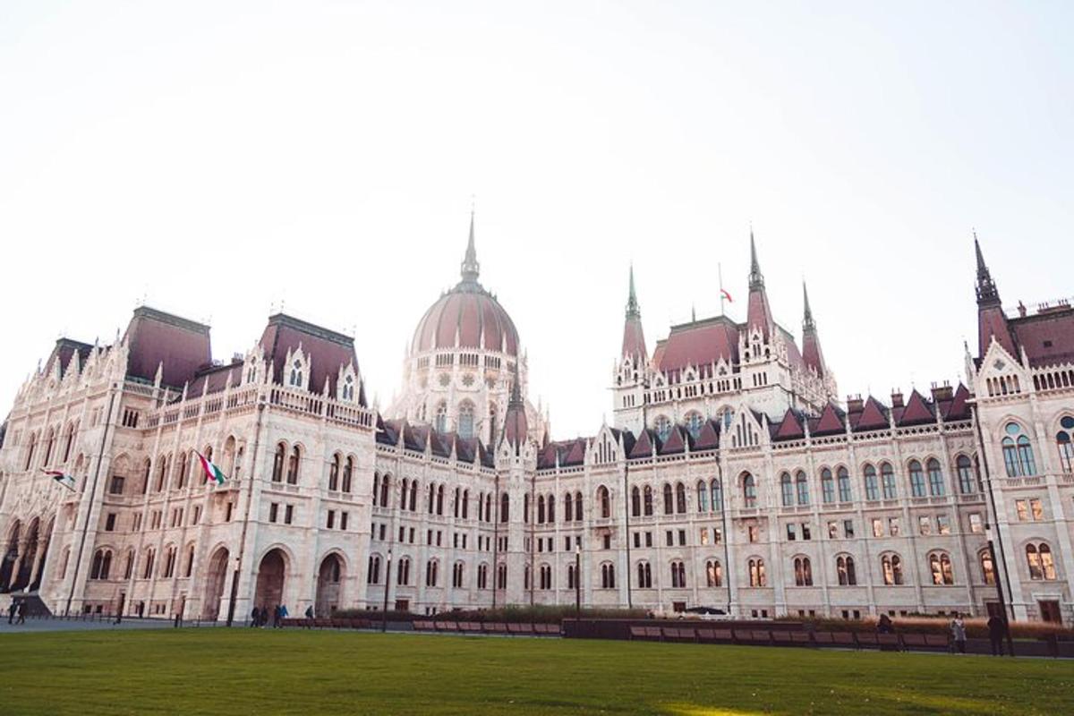 a large building with a green field in front of it
