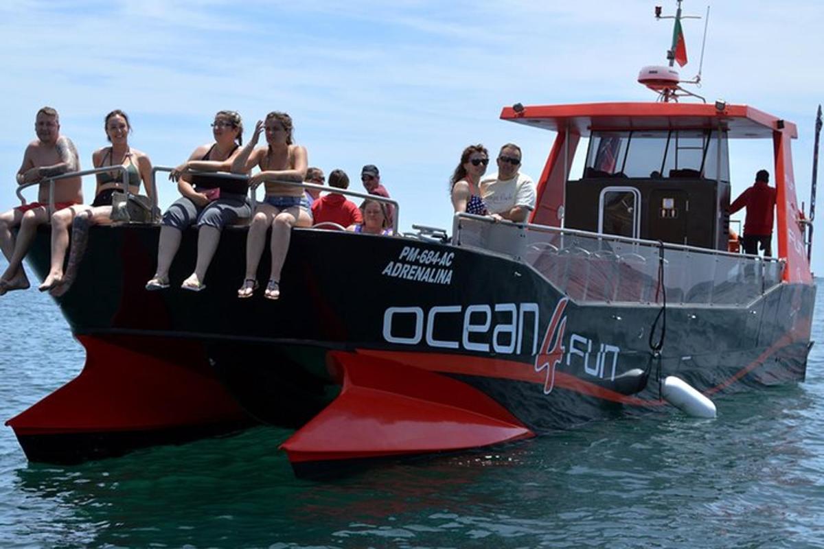 a group of people sitting on a boat in the water