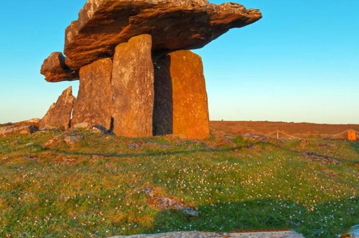 a large rock sitting on top of a field