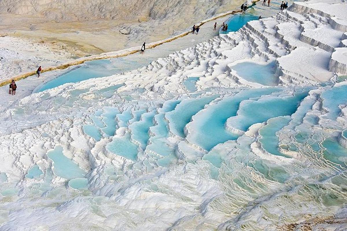 a group of people standing on top of a glacier