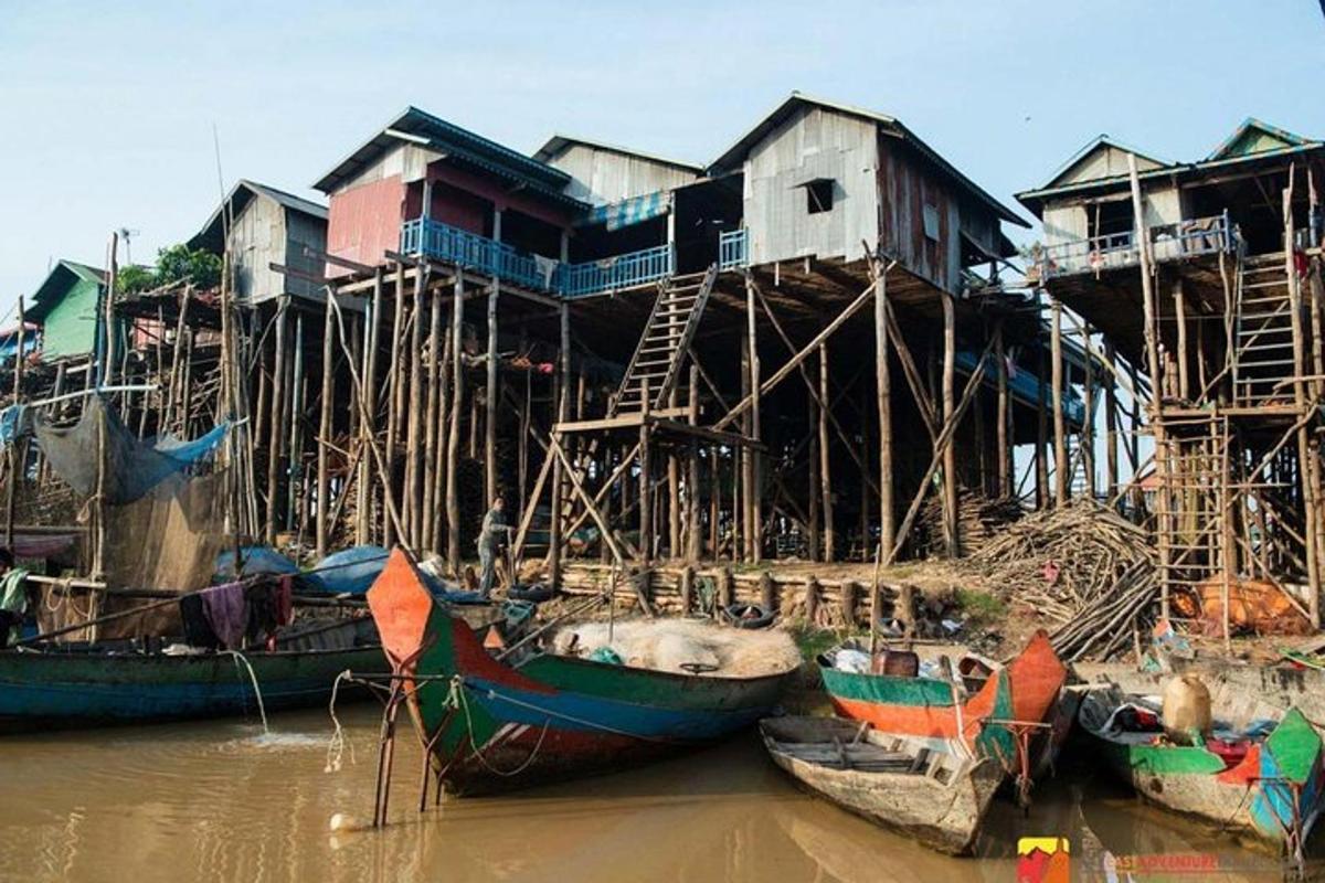 um grupo de barcos na água ao lado de casas