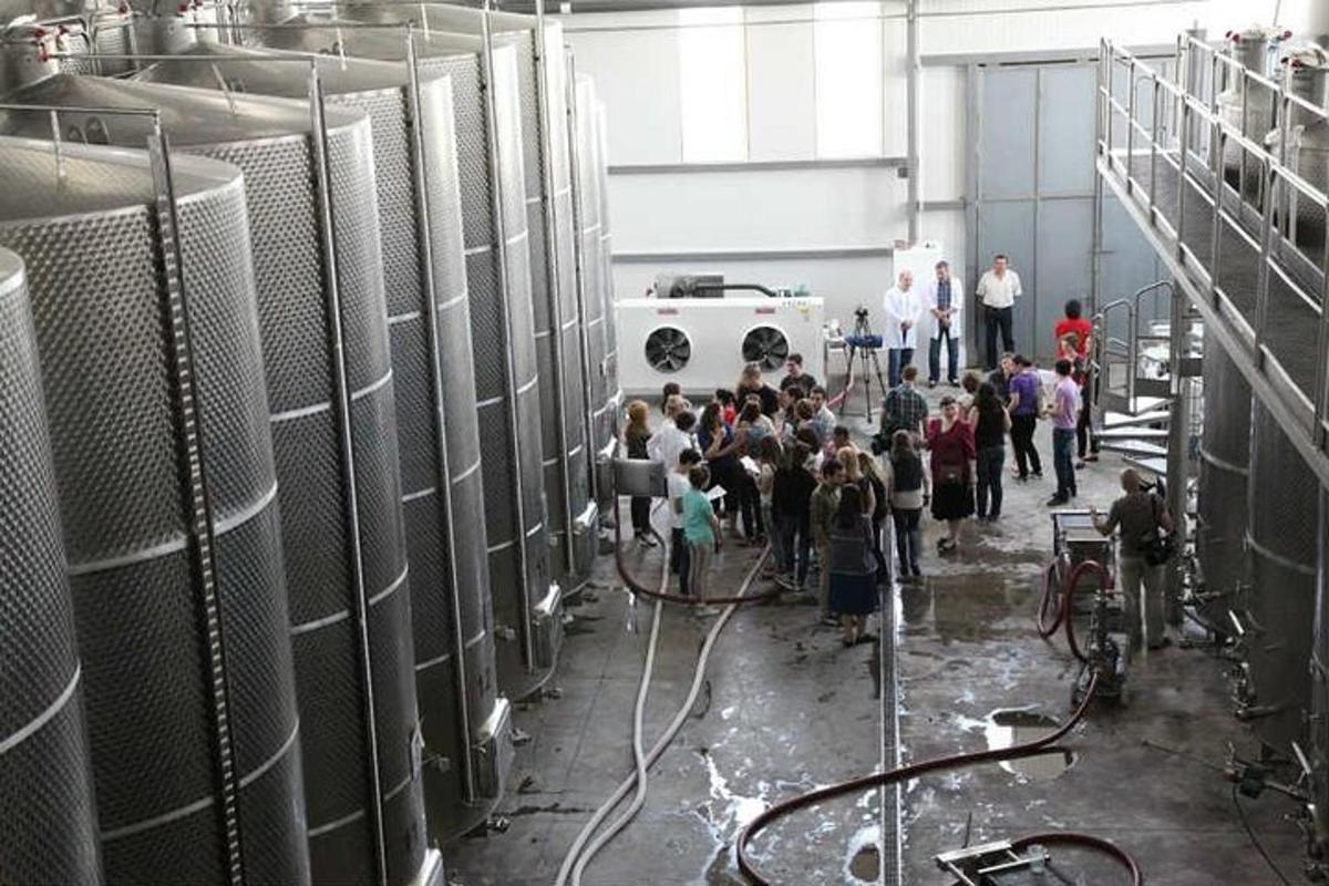 a group of people standing around in a factory