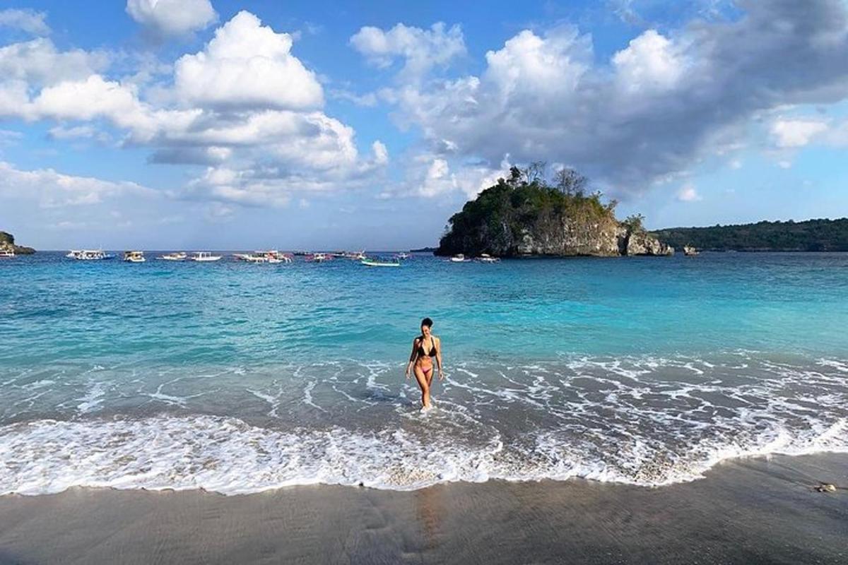 a woman walking in the water at the beach