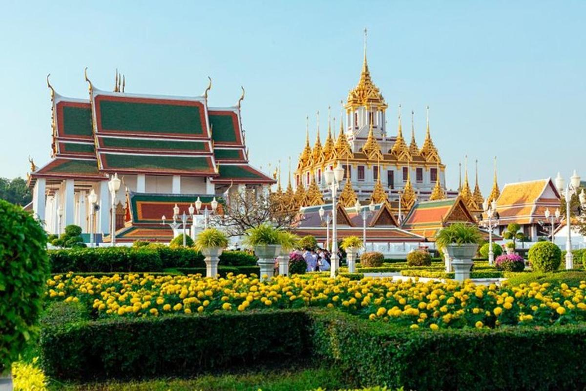 a palace with a garden of flowers in front of it