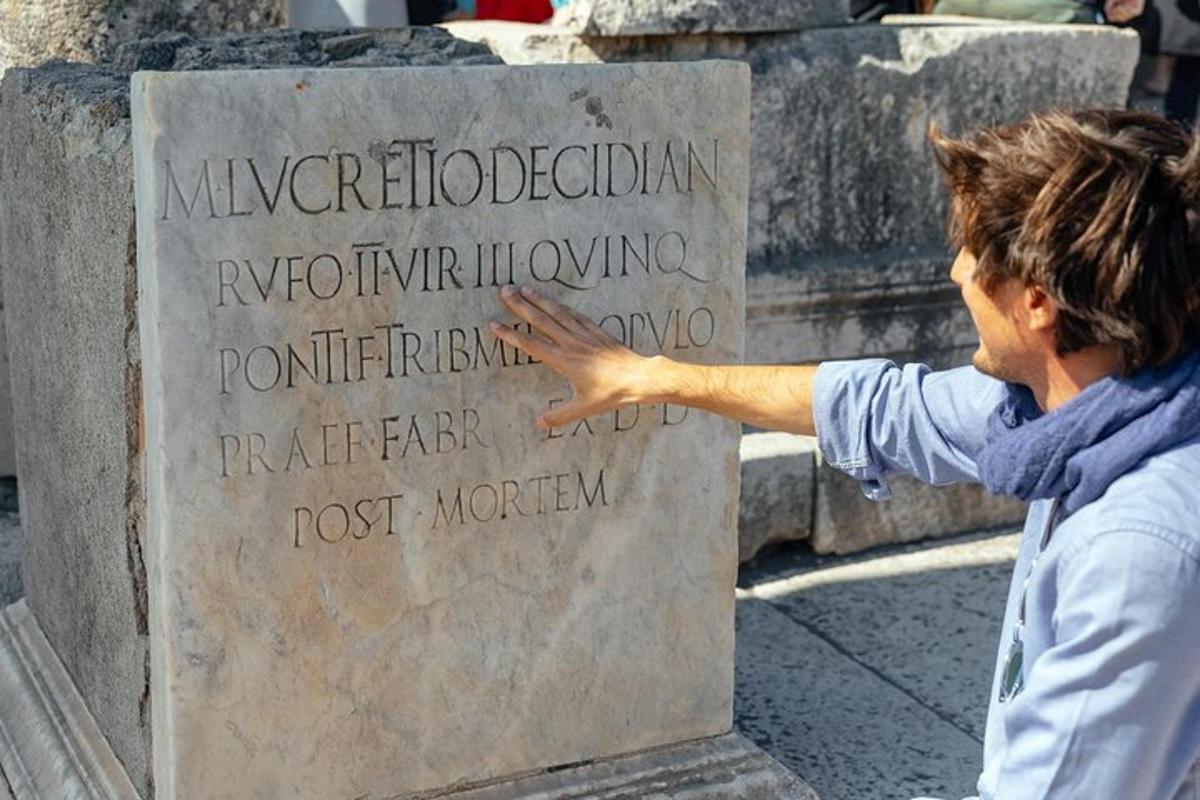 un uomo che indica un monumento in un cimitero