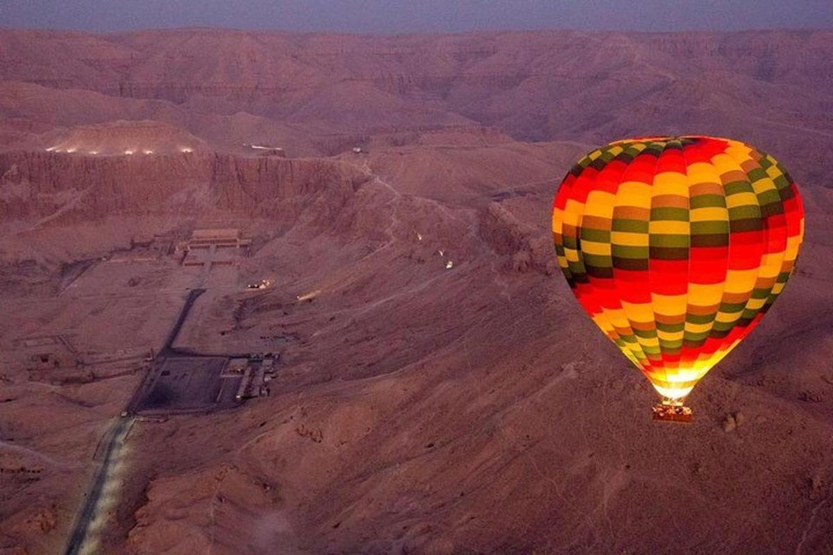 a hot air balloon flying over the desert