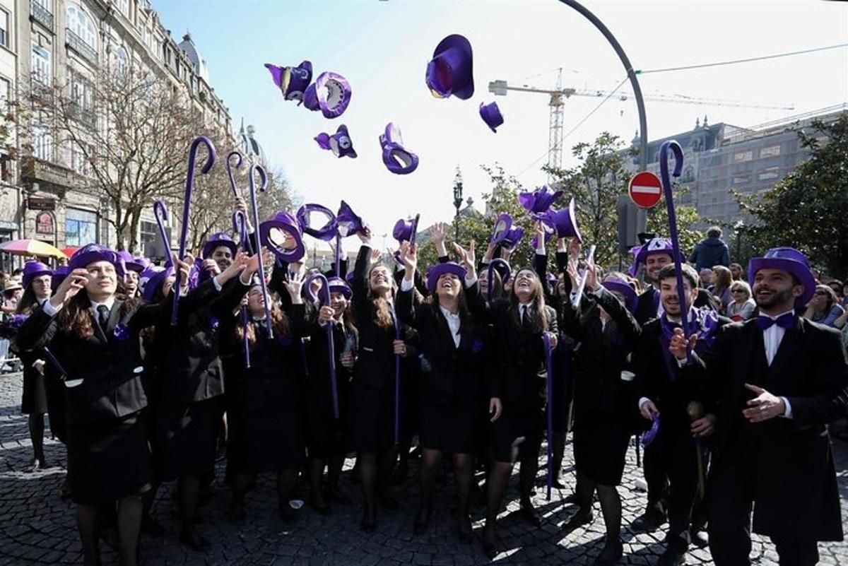 a group of graduates throwing their hats in the air