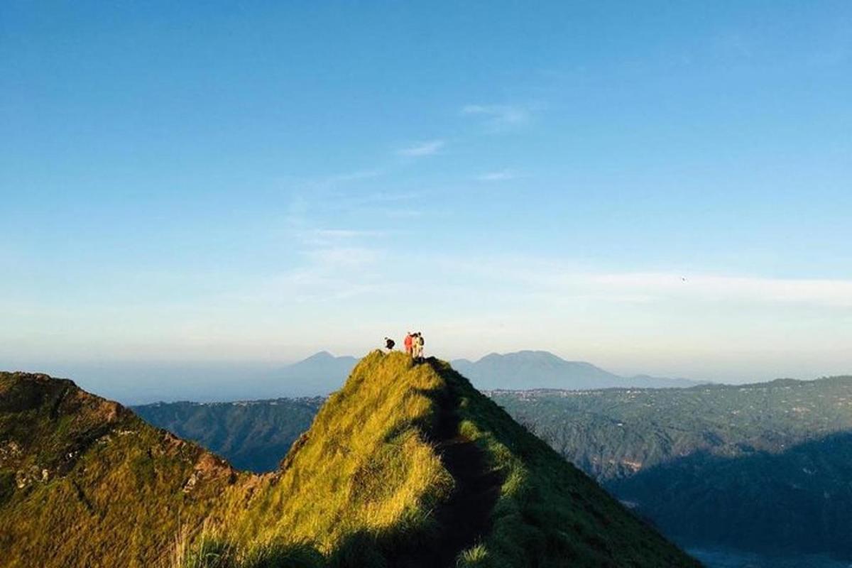 two people standing on top of a mountain