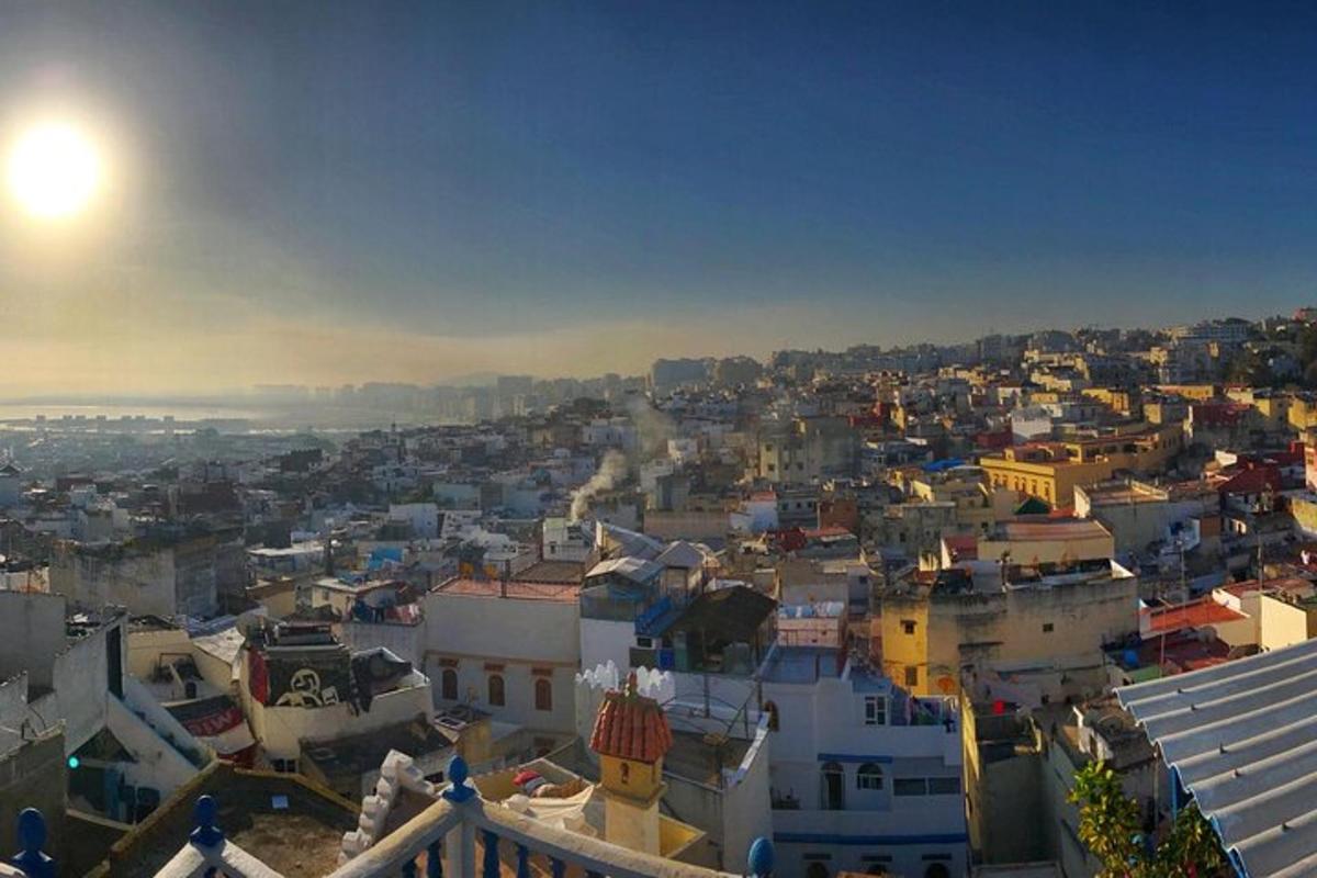 a view of a city with the sun in the sky