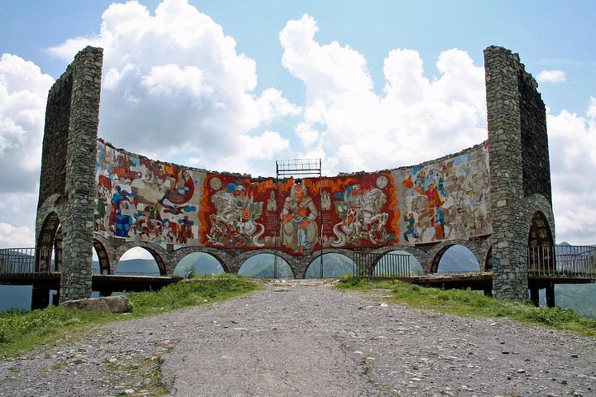 a large mural on the side of a bridge
