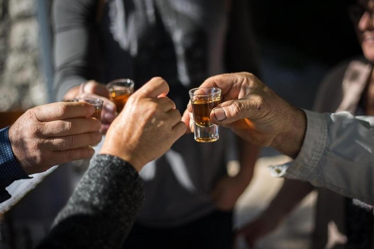 a group of people holding up glasses of beer
