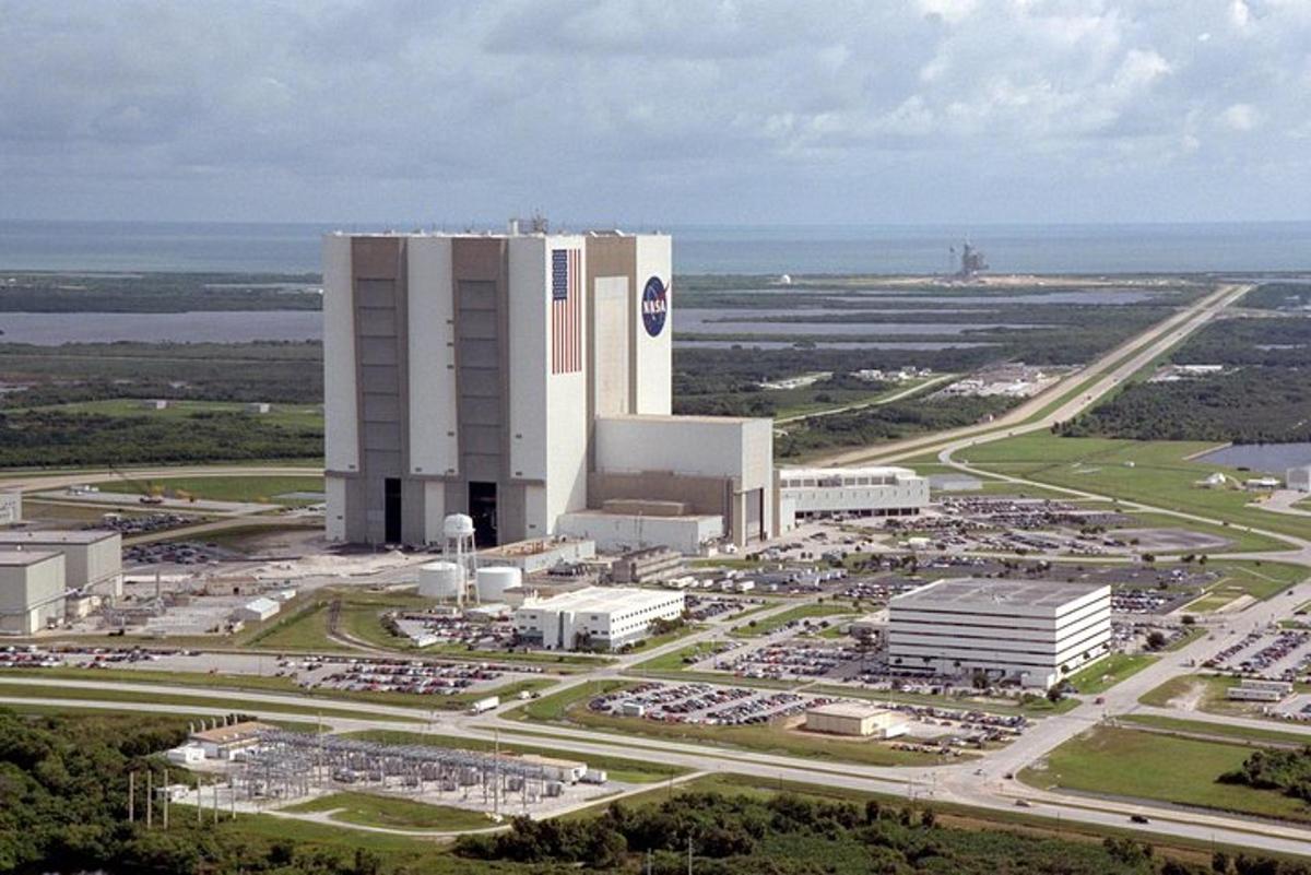 Una vista aérea de un gran edificio con estacionamiento.