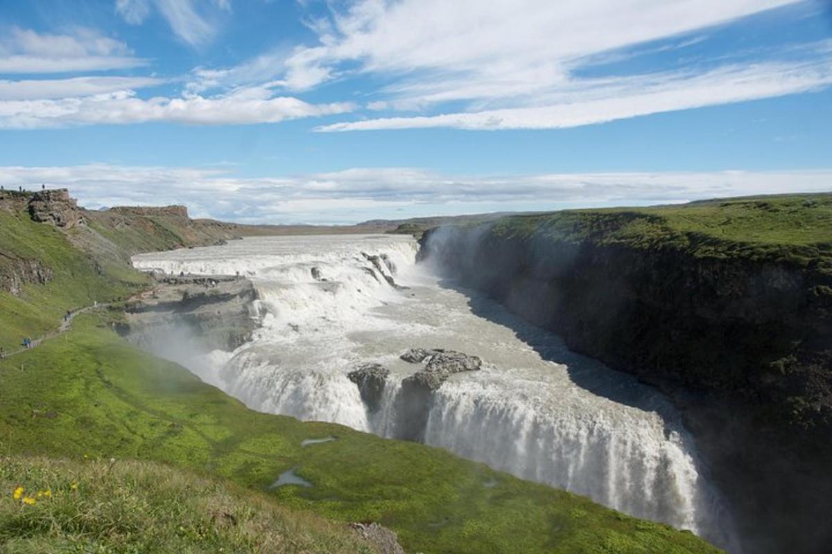 a waterfall on the side of a river