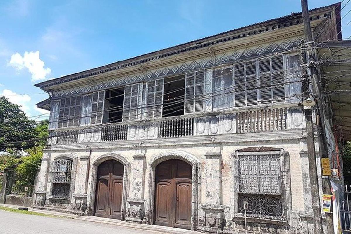 an old building with wooden doors on a street