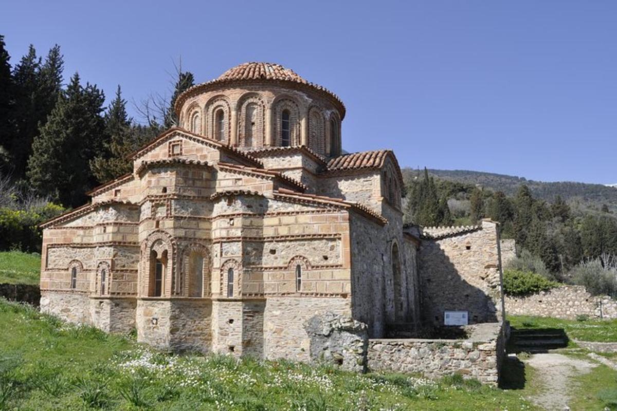 ένα παλιό πέτρινο κτίριο με πύργο σε έναν λόφο