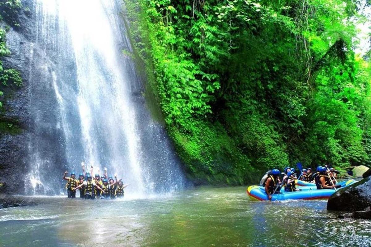 a group of people on a raft in front of a waterfall